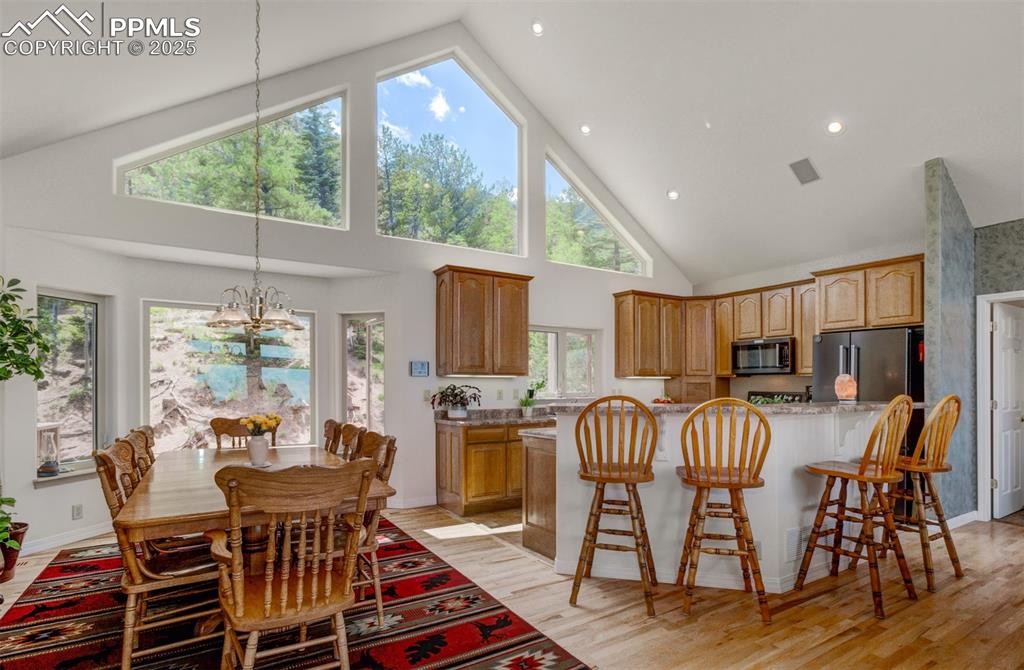 Image 10 of 46: Kitchen and Dining area with hard wood flooring/ceramic tile and plenty of 