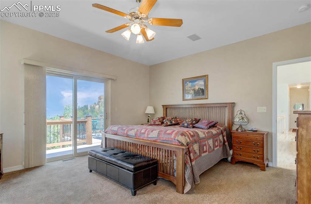 Image 17 of 46: Primary Bedroom on the main level with a walk out and an en suite 5 piece b
