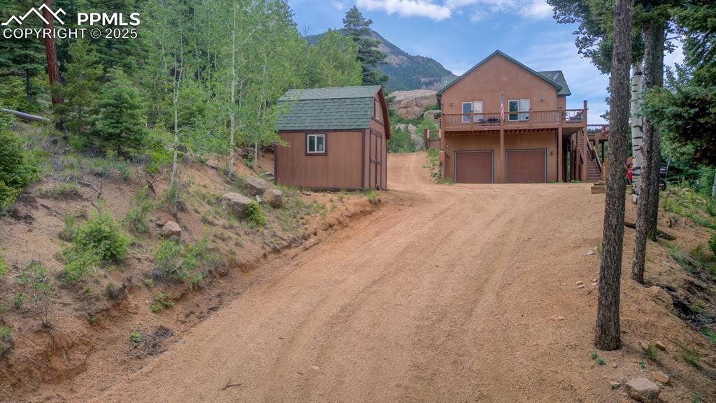 Image 2 of 46: Driveway leading to the front of home