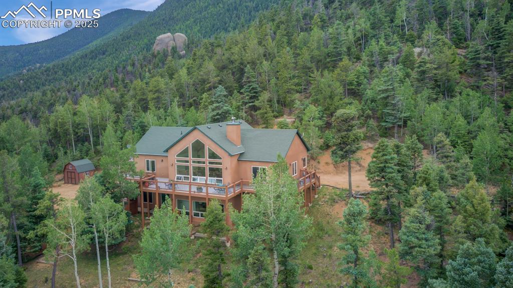 Image 41 of 46: Aerial view of this amazing home nestled into the mountain side!