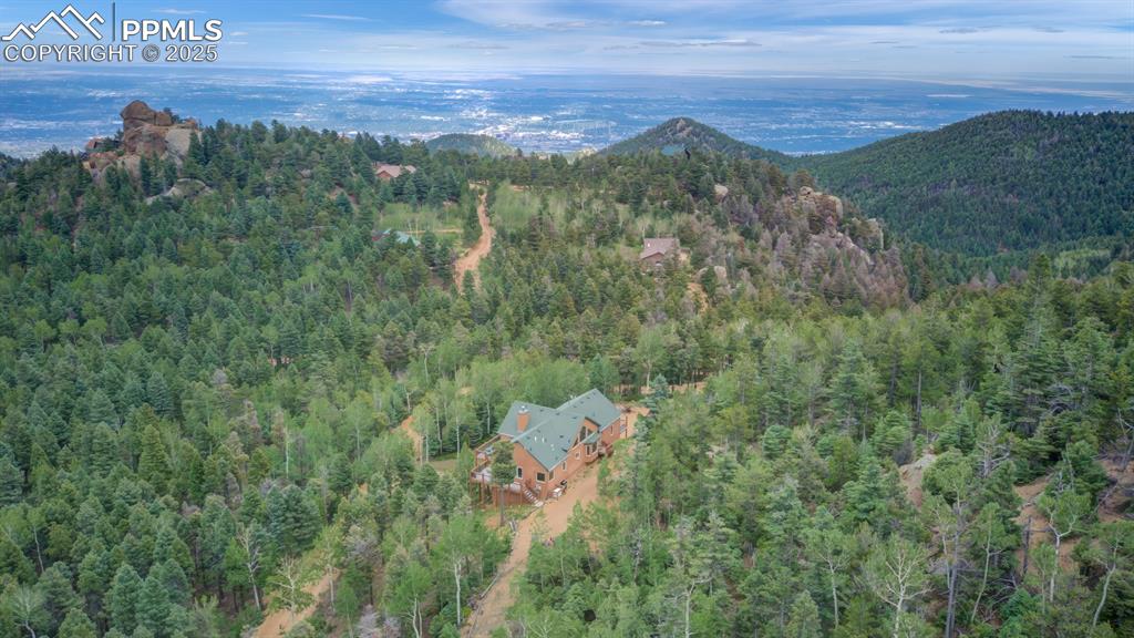 Image 42 of 46: Aerial view of the home with the city beyond the mountains!!!