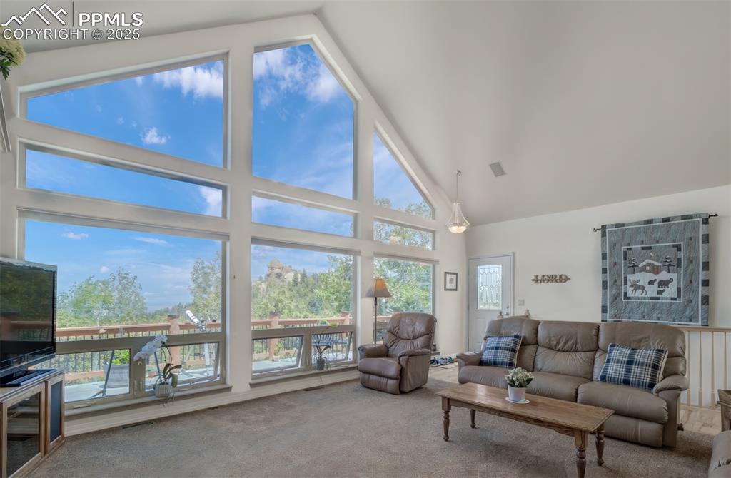 Image 6 of 46: Living room with a focus on the wall of windows!