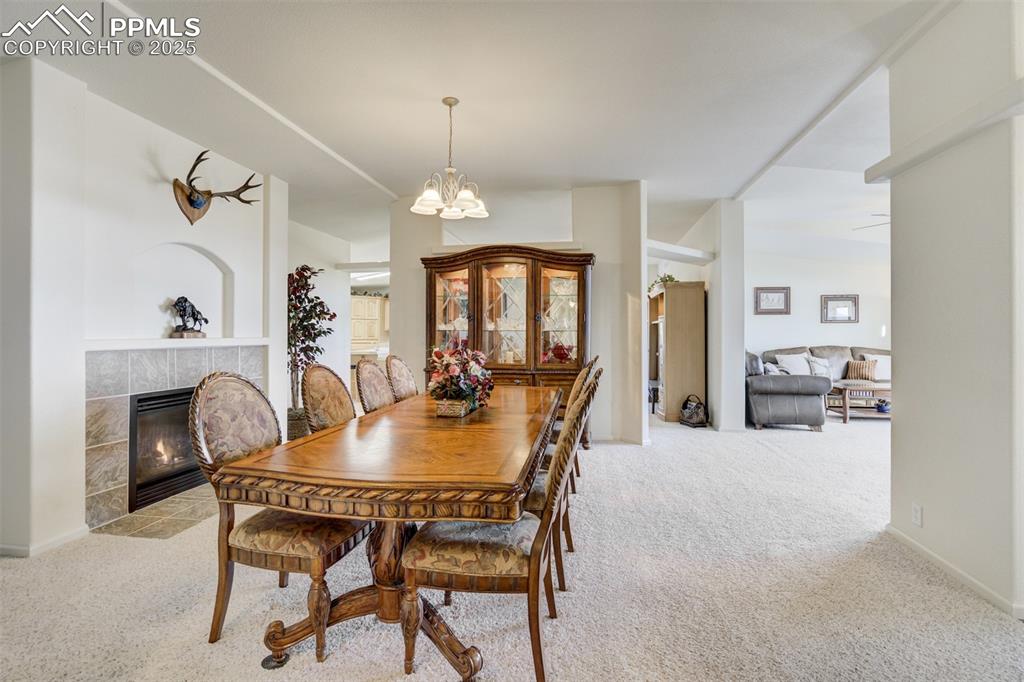 Image 14 of 46: Formal dining area with fireplace
