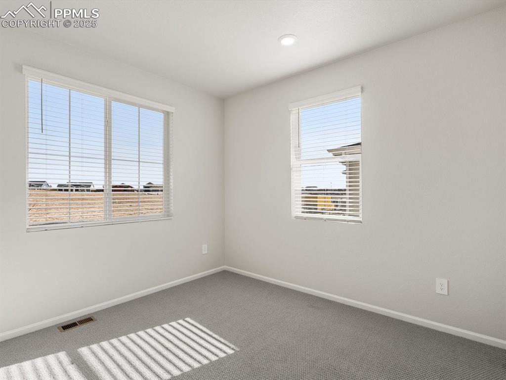 Image 12 of 28: Carpeted spare room featuring baseboards