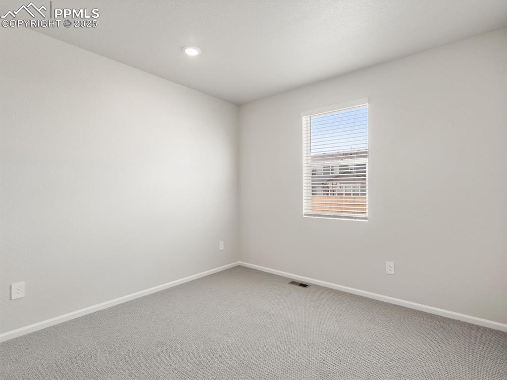 Image 14 of 28: Carpeted empty room with baseboards and recessed lighting