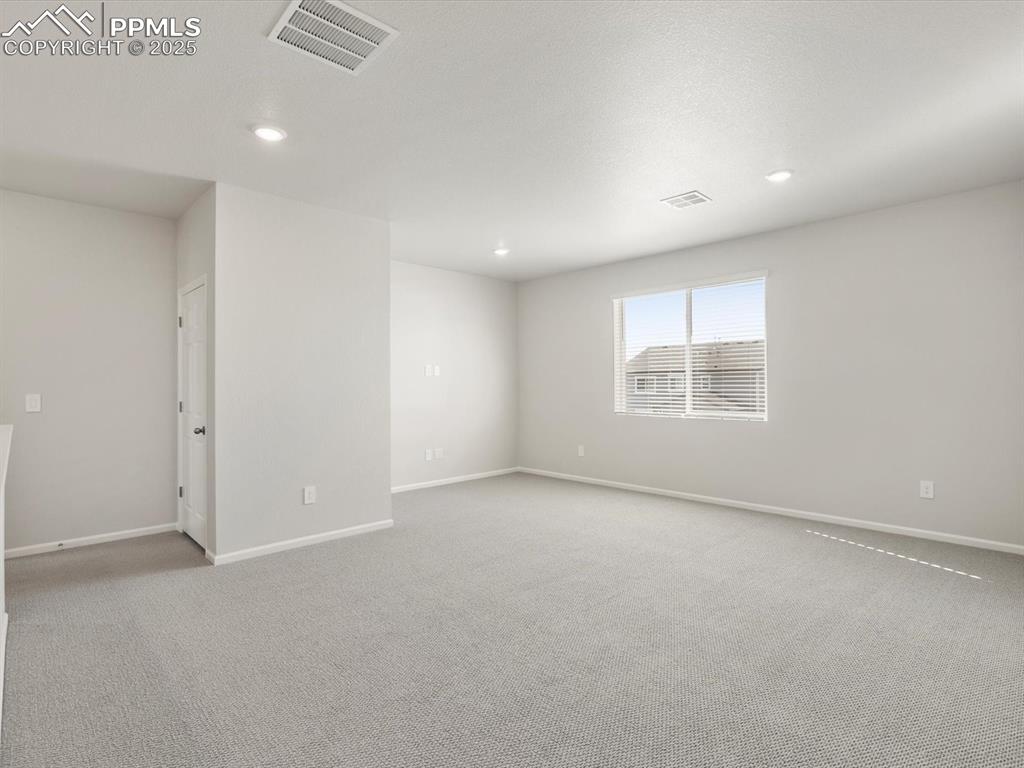 Image 15 of 28: Spare room featuring light carpet and recessed lighting