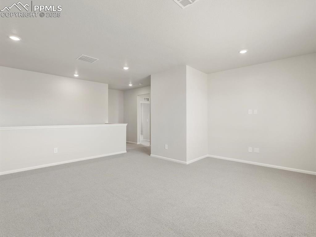 Image 16 of 28: Spare room with recessed lighting and light colored carpet