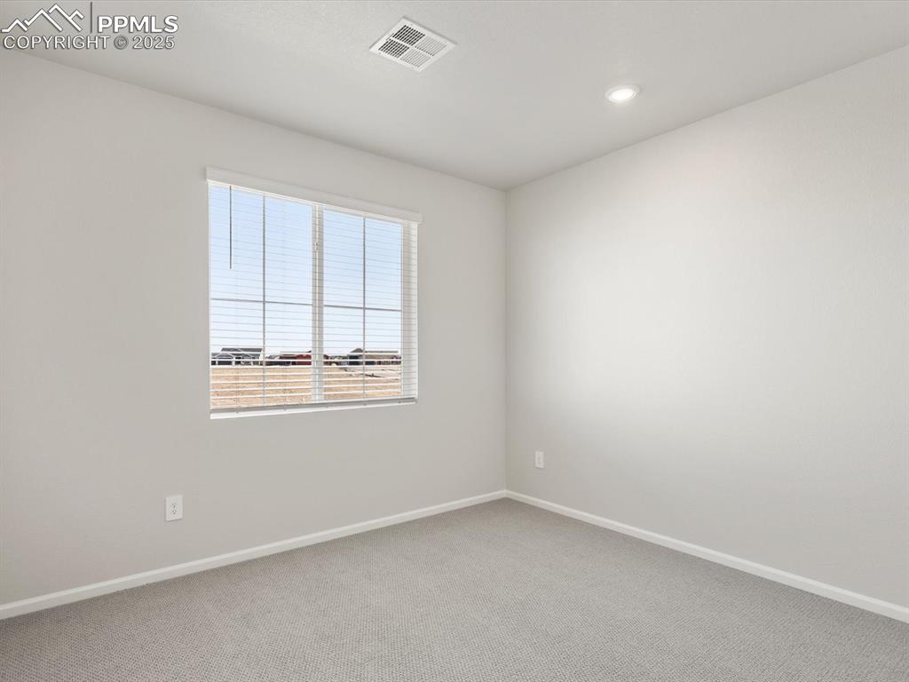 Image 18 of 28: Carpeted spare room with baseboards and recessed lighting