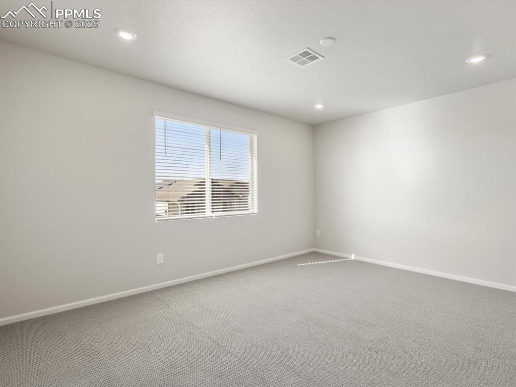 Image 22 of 28: Carpeted empty room with baseboards and recessed lighting
