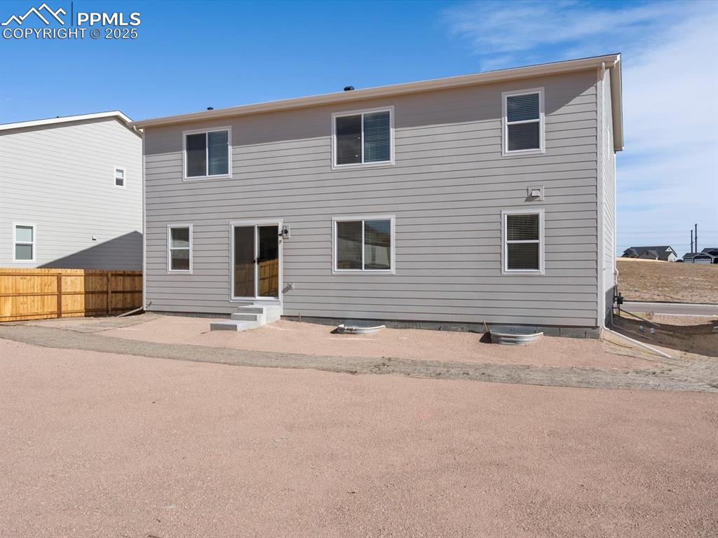 Image 27 of 28: Rear view of property with entry steps