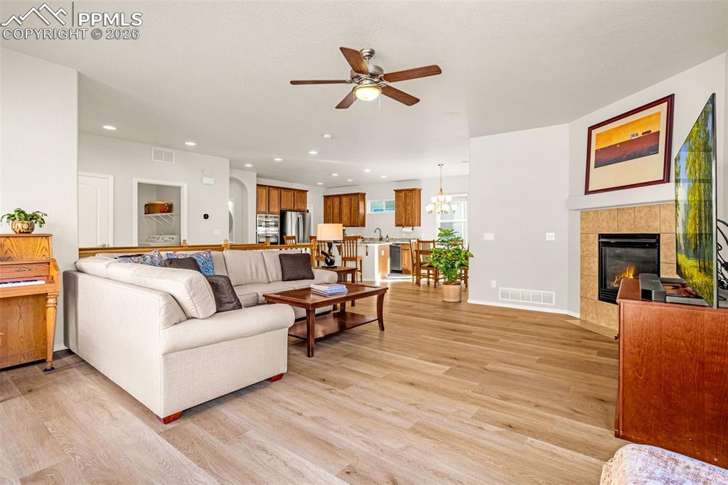 Image 13 of 42: New LVP flooring, gas fireplace