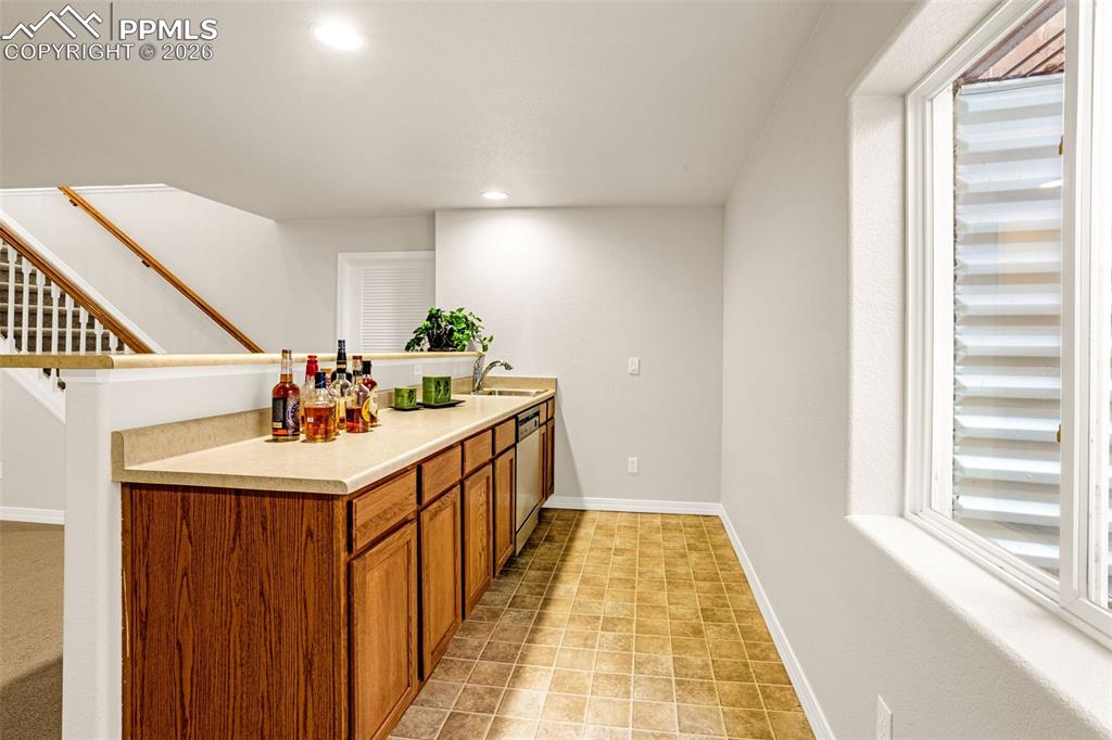 Image 24 of 42: Basement Rec room wet bar