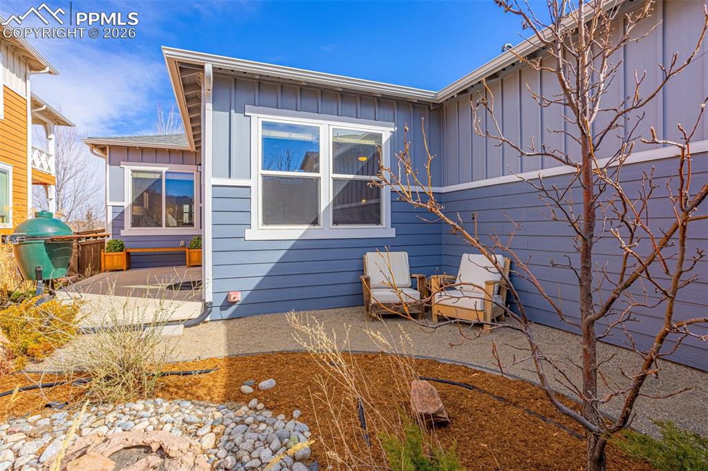 Image 32 of 42: Back of property featuring board and batten siding and a patio area