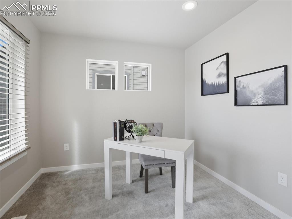 Image 14 of 50: Main level home office/ flex space off of the kitchen.