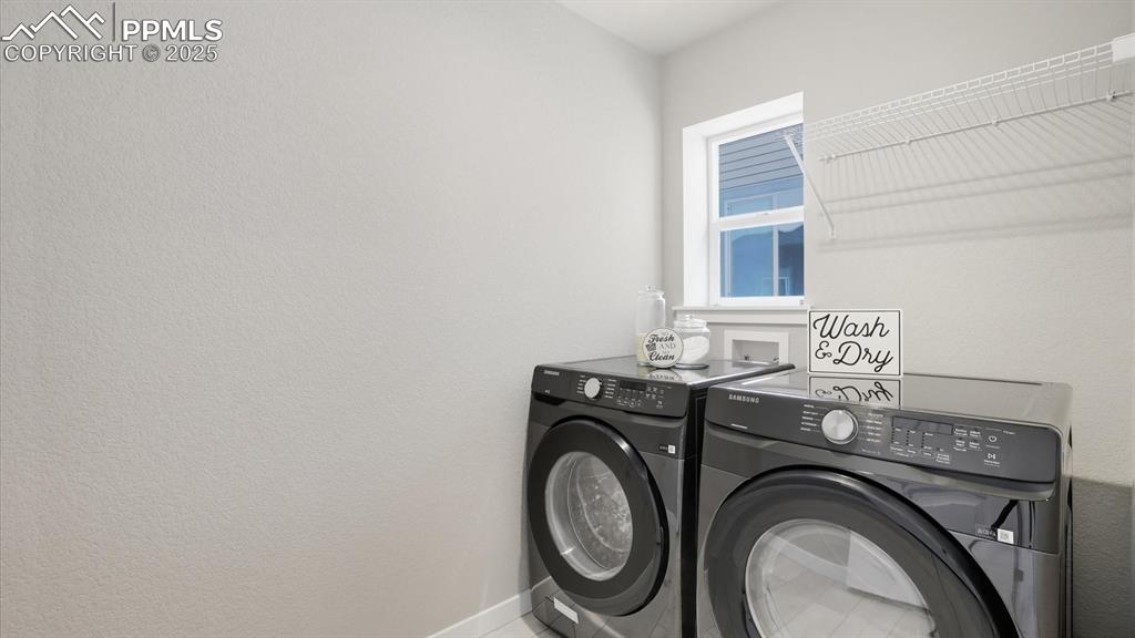 Image 18 of 50: Main level Laundry with window and Samsung washer and dryer.