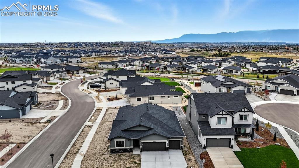 Image 2 of 50: Aerial view of home and corner lot with beautiful mountain views.