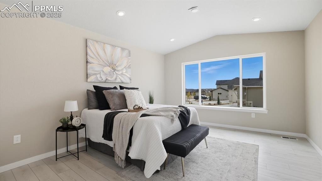 Image 20 of 50: Vaulted Main level Primary Suite with neutral carpet, adjoining 5-piece Bat