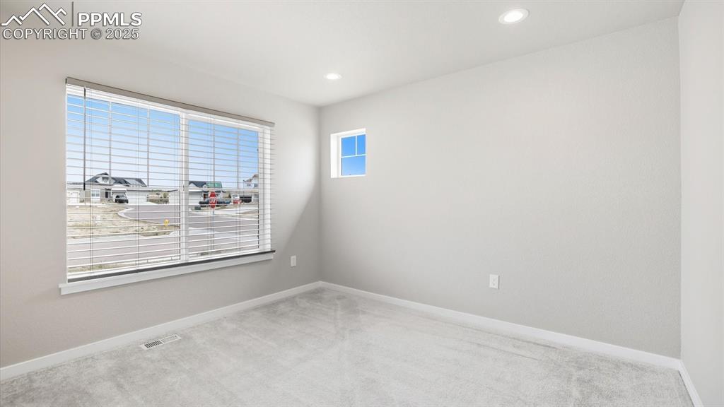 Image 26 of 50: Bedroom #1 off the front Entry with neutral carpet and large view window to