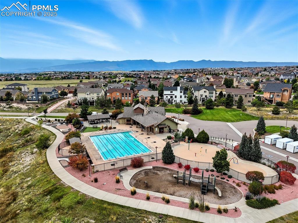 Image 3 of 50: Wolf Ranch Clubhouse pool and adjacent playground 