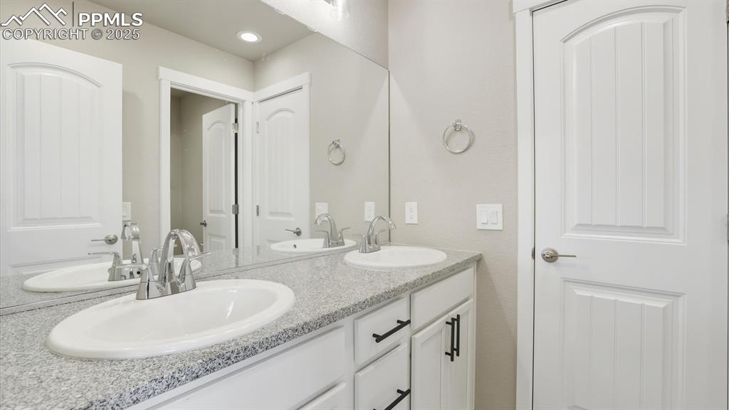 Image 30 of 50: Dual sink vanity with quartz countertops in the Front Bathroom.