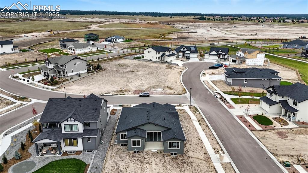 Image 4 of 50: Aerial rear view of home and lot.