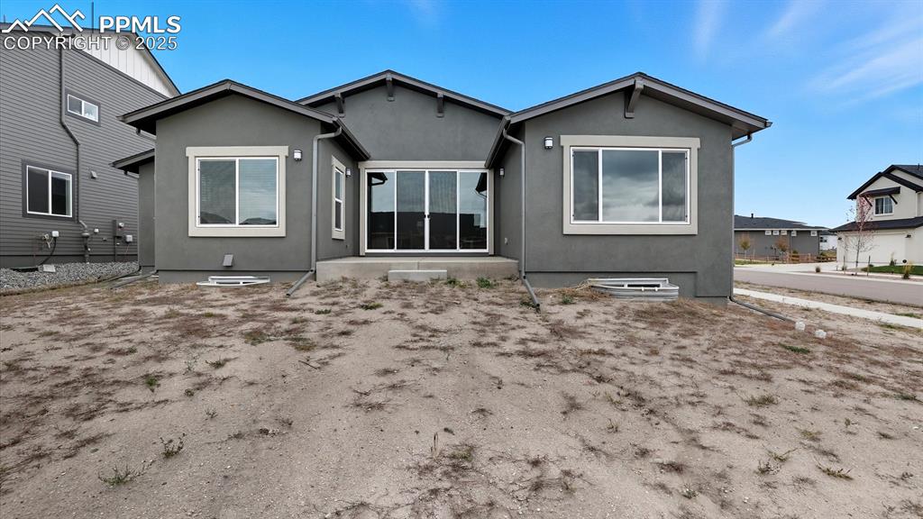 Image 45 of 50: Rear view of home and 0.27 acre corner lot.