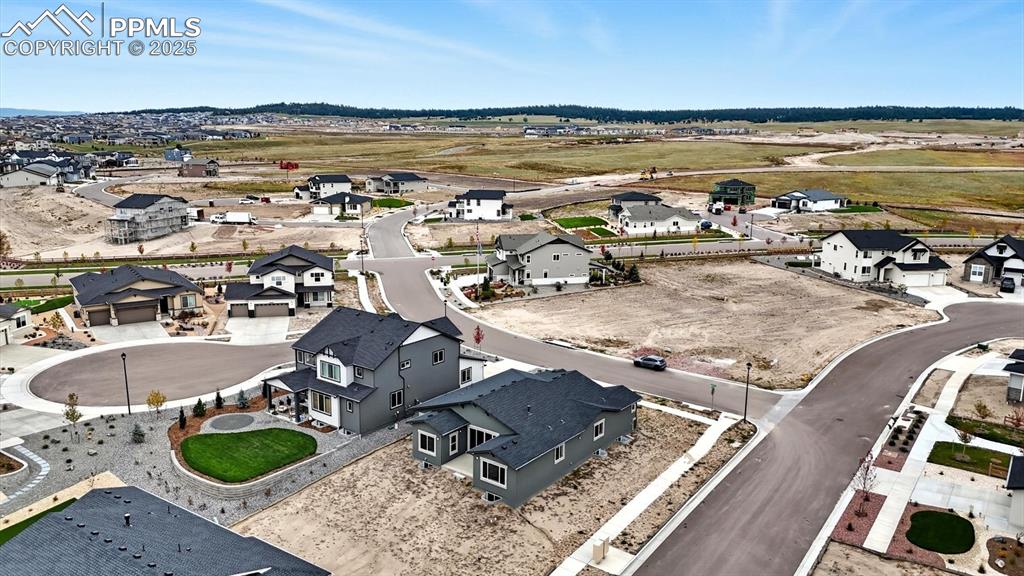 Image 47 of 50: Aerial view of home and corner lot.