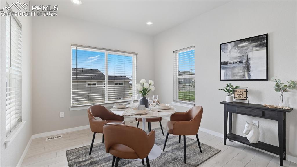 Image 8 of 50: Sunny Dining Area located off the Kitchen for convenient food service, ente