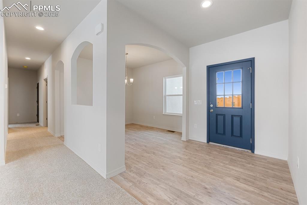 Image 4 of 22: Entryway with recessed lighting, light wood-style flooring, and a chandelie