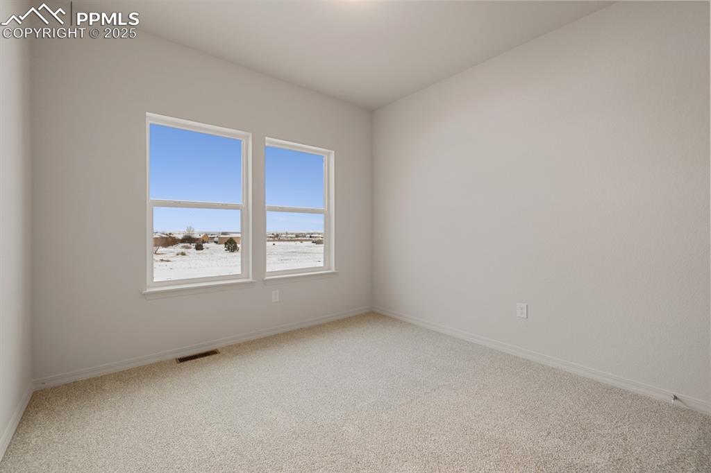 Image 5 of 22: Spare room featuring light colored carpet