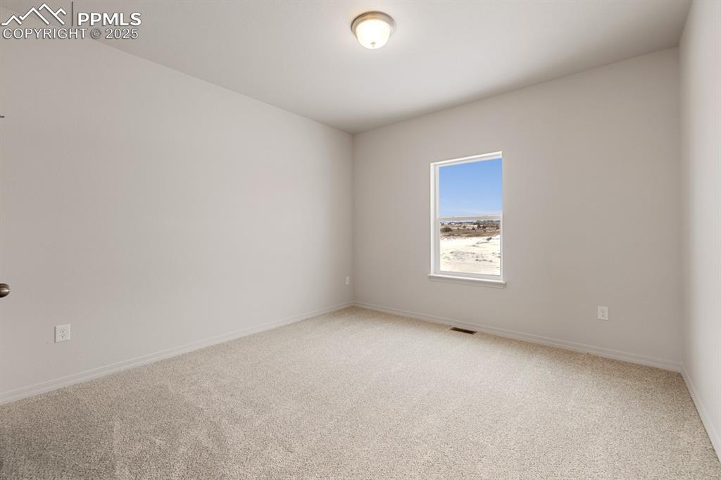 Image 7 of 22: Spare room featuring light colored carpet and baseboards
