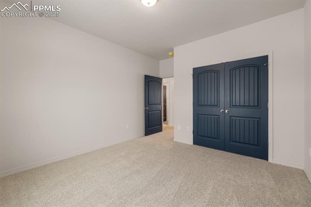 Image 8 of 22: Unfurnished bedroom with carpet flooring and a closet