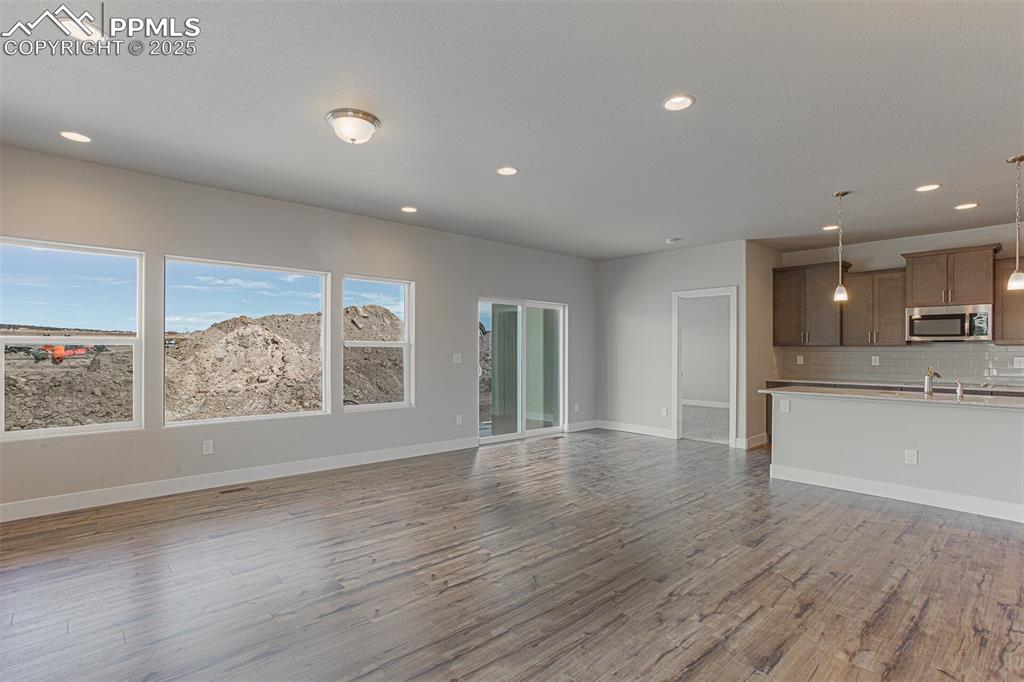 Image 6 of 10: Unfurnished living room featuring recessed lighting and light wood finished