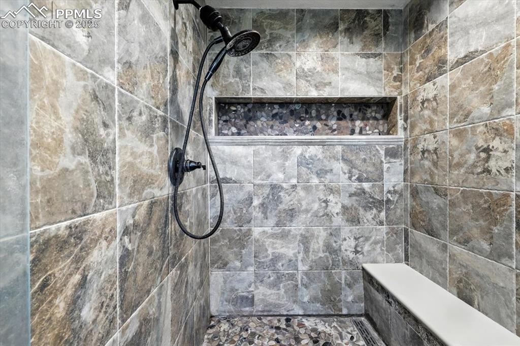 Image 16 of 29: Full bathroom with tiled shower