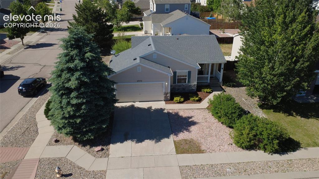 Image 4 of 31: Single-story residence featuring a covered front porch, an attached garage,