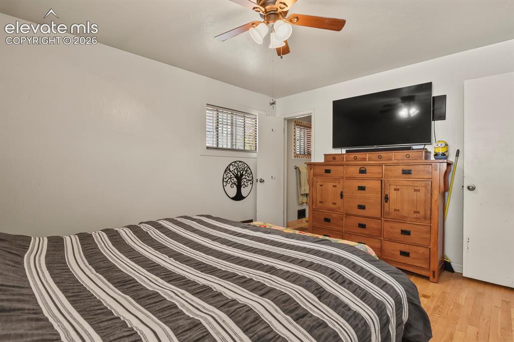 Image 11 of 28: Wood-finish flooring with a ceiling fan light fixture