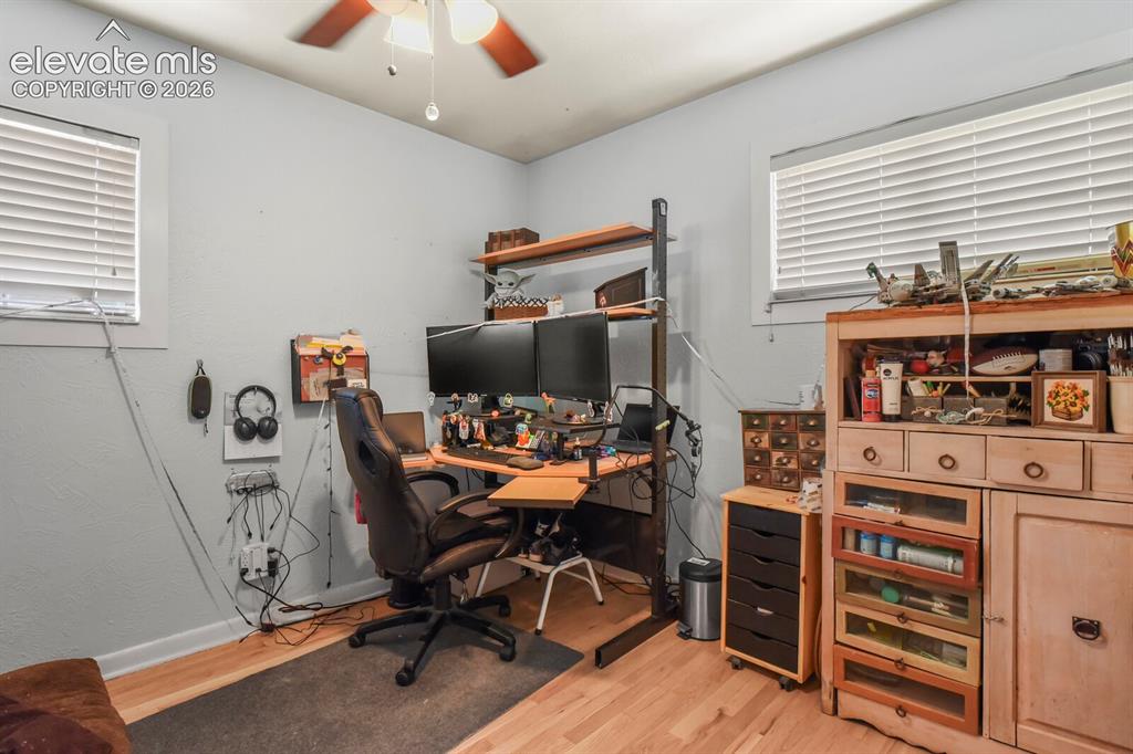 Image 15 of 28: Wood-finish flooring, ceiling fan with integrated lighting, and multiple wi