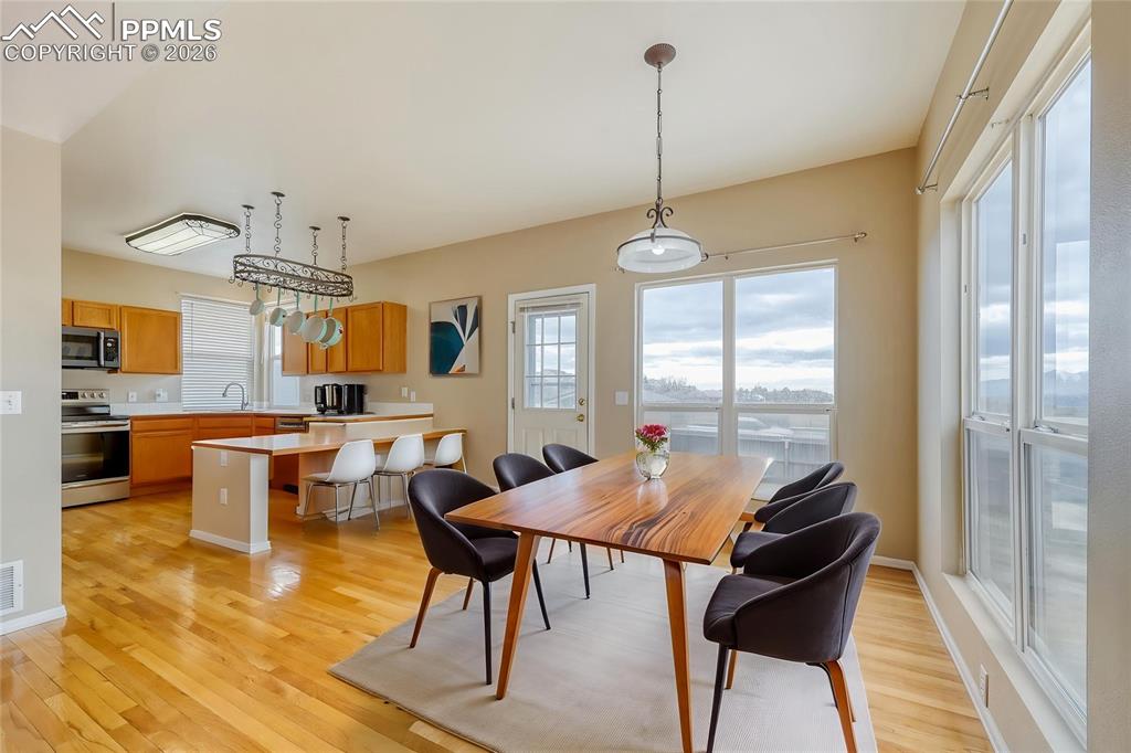 Image 11 of 38: Dining room featuring light wood-style floors and baseboards