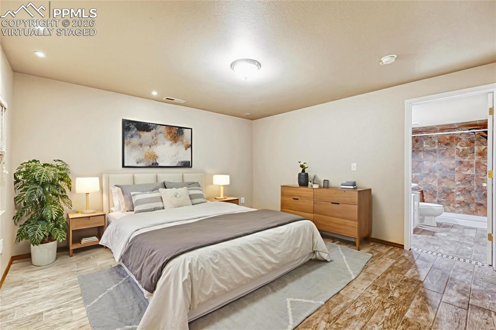Image 24 of 30: Virtually Staged as a Bedroom/bonus room featuring wood-finish flooring, re