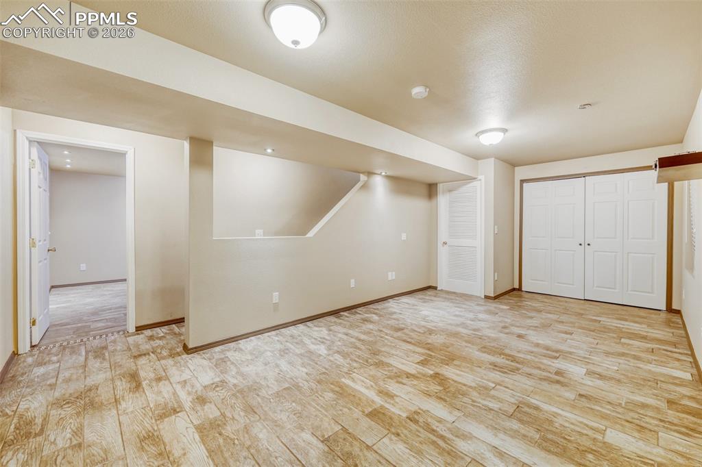 Image 27 of 30: Recessed and flush mount lighting illuminates this recreation room featurin