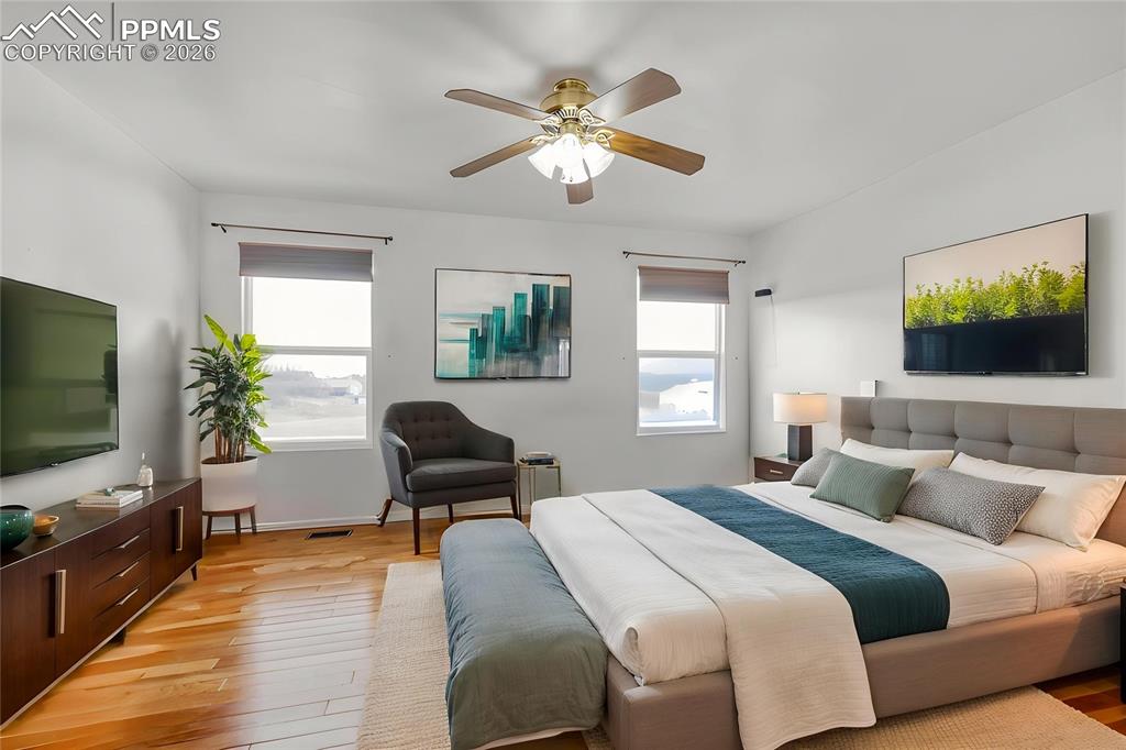 Image 28 of 38: Bedroom featuring light wood-style floors and a ceiling fan