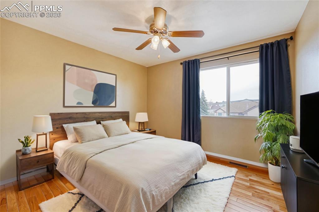 Image 29 of 38: Bedroom with light wood-style flooring and ceiling fan