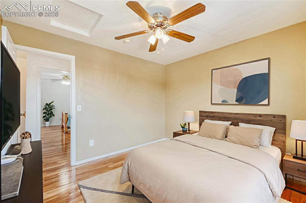 Image 30 of 38: Bedroom featuring light wood finished floors and a ceiling fan