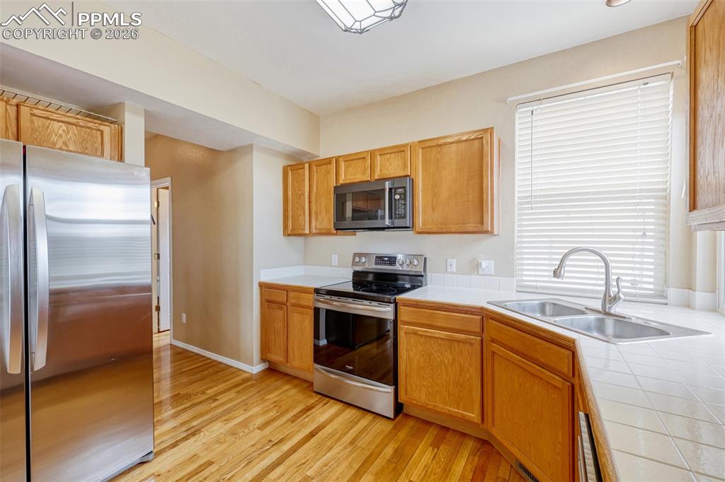 Image 8 of 30: Hardwood Floors, stainless appliances