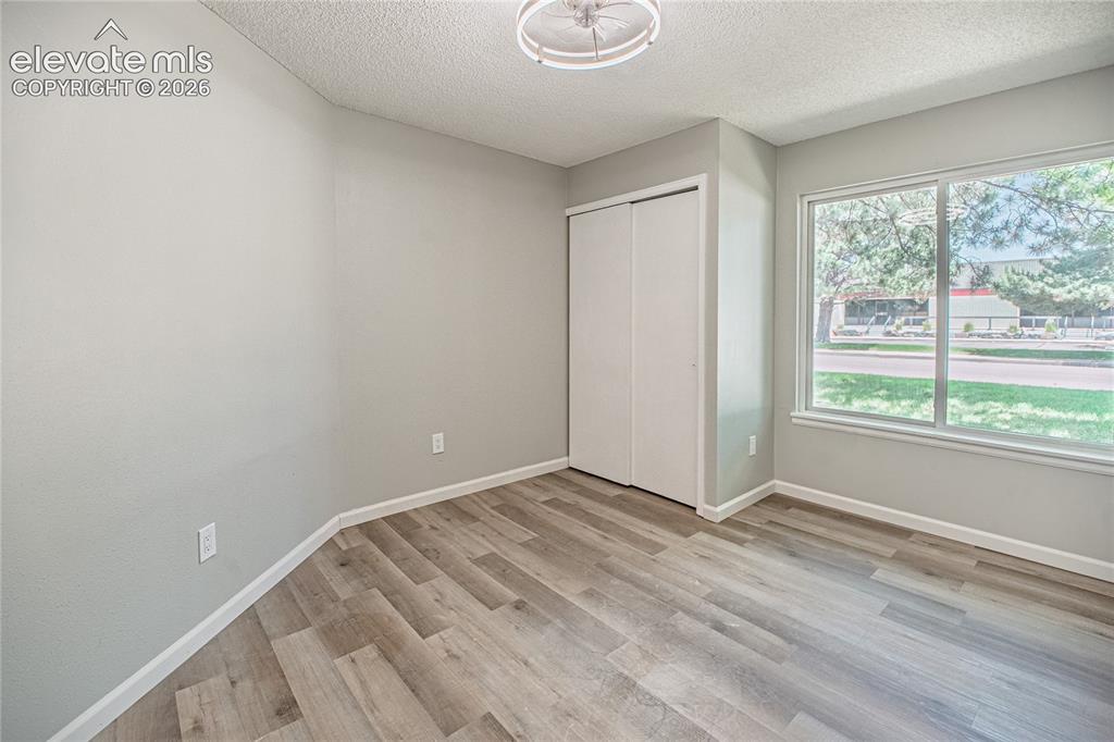 Image 18 of 37: Interior room featuring wood-finish flooring, light gray walls, a built-in