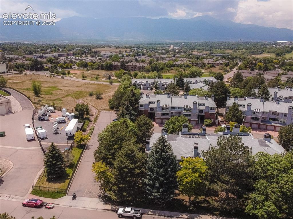 Image 27 of 37: Townhome community featuring multi-level residences, attached garages, and