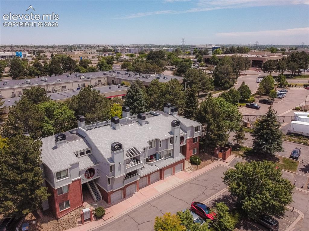 Image 36 of 37: Multi-story residential building featuring red brick and gray siding