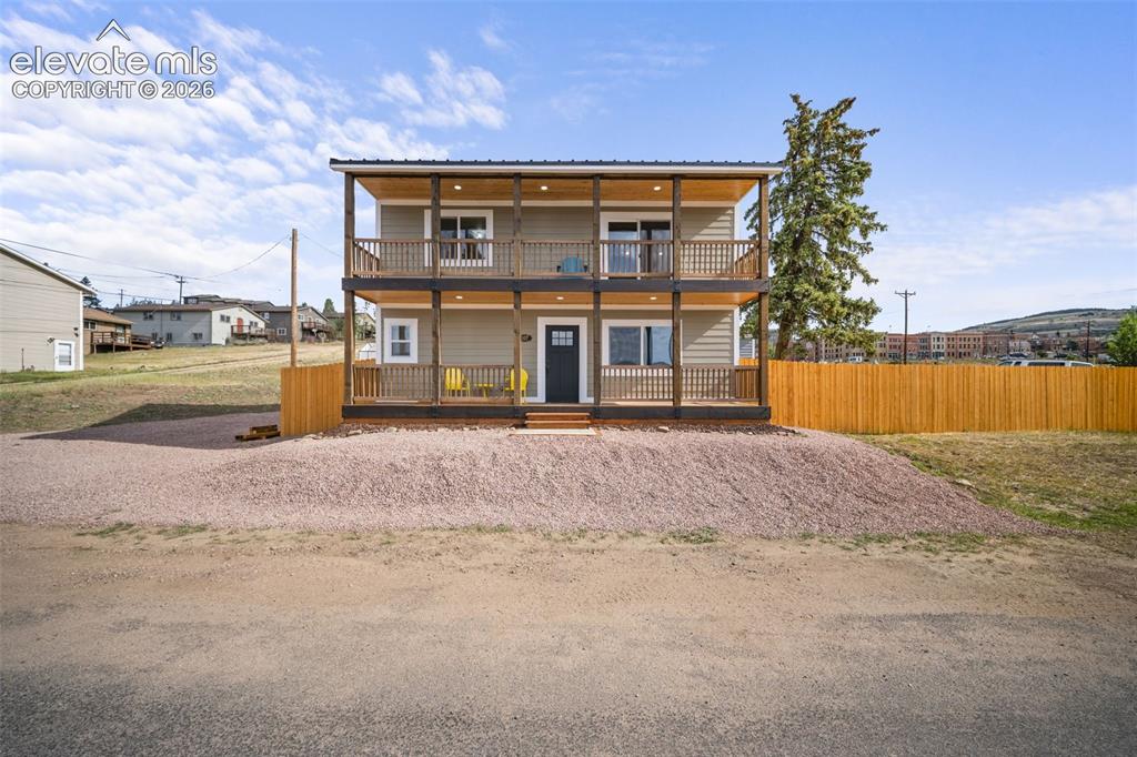 Image 2 of 30: Covered front porch and upper deck