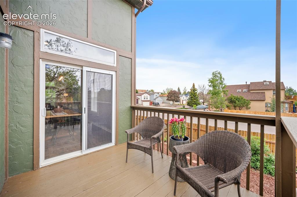 Image 29 of 37: Private balcony featuring wood-finish decking and a coordinating wood raili