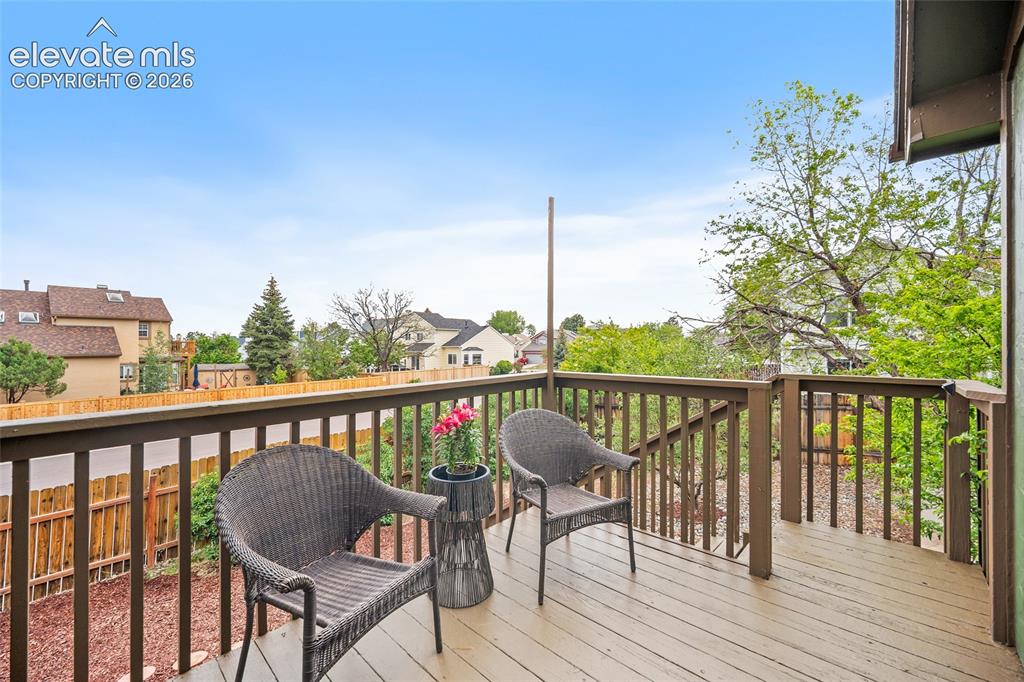 Image 30 of 37: Spacious outdoor deck featuring wood-finish flooring and a full-height rail
